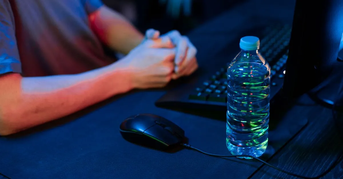 Hand on a gaming mouse at a desk during a click speed test measuring clicks per second
