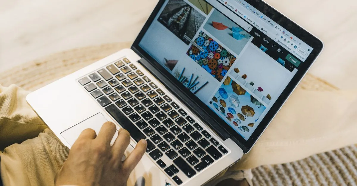 Web designer building a CSS grid layout on a laptop screen at a desk