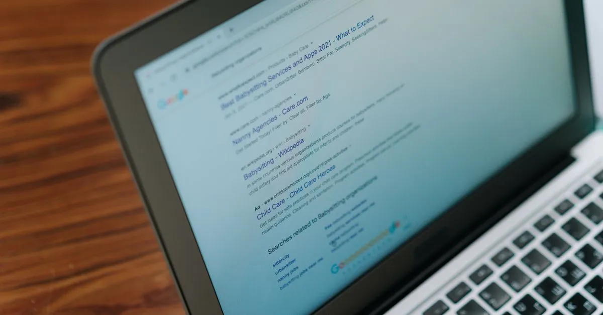 Web designer working on a website layout on a laptop, choosing a favicon icon