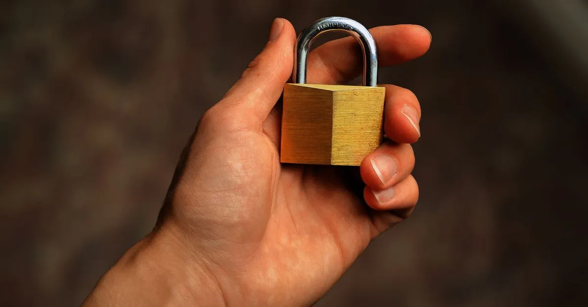 Padlock resting on a laptop keyboard illustrating password strength and account security