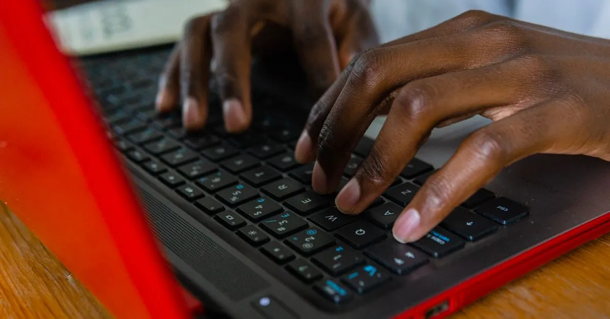Hands typing fast on a laptop keyboard during a typing speed test