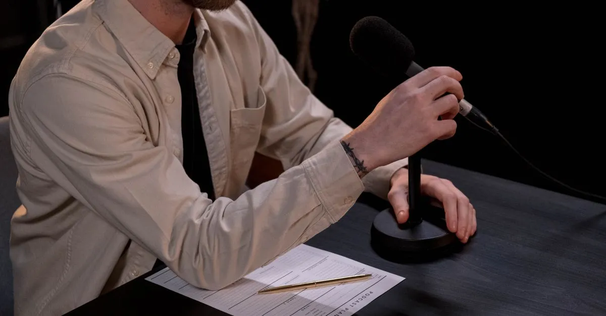 Condenser microphone on a desk set up for recording voice online in a browser